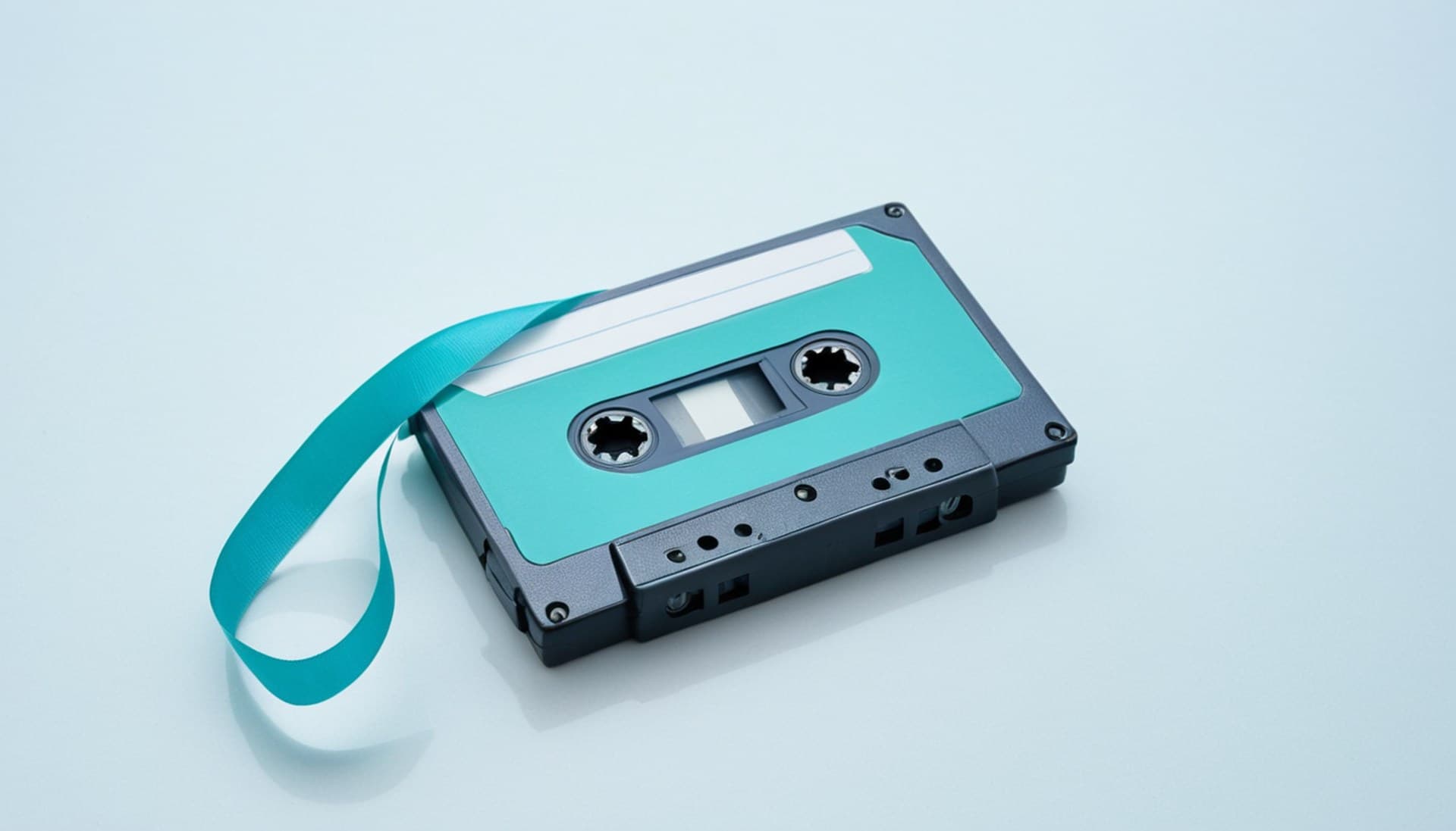 A cassette tape with its magnetic ribbon spilled into a loop on a pale studio surface, a metaphor for rewinding Claude Code checkpoints